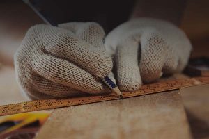 a contractor drawing a straight line on wood