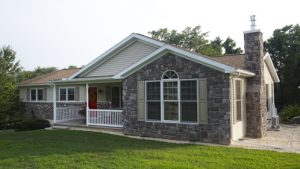 newly remodeled home with stone siding