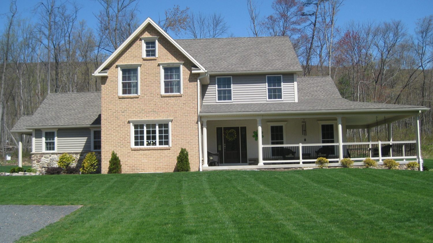 newly constructed home with a large wrap-around porch