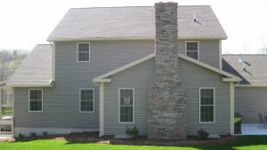 newly constructed home with stone fireplace