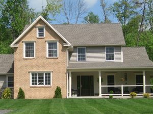 newly constructed home with a large wrap-around porch