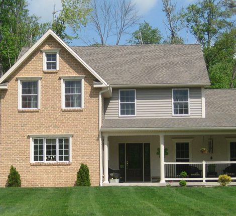 newly constructed home with a large wrap-around porch