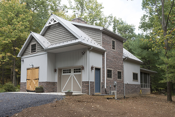 newly constructed country home with barn door styling