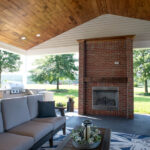 couch, coffee table, and fireplace under a new covered porch addition