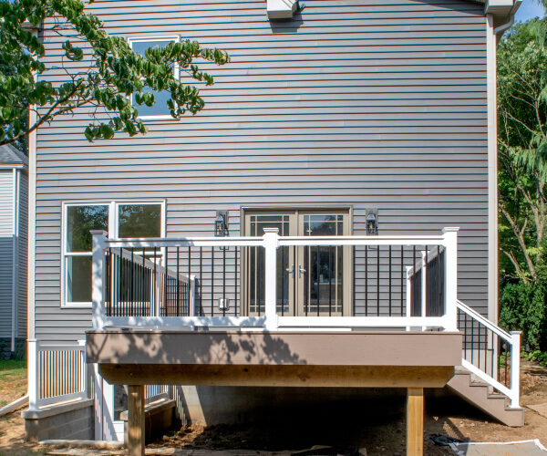 back view of a remodeled home with new siding and deck