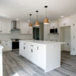 kitchen with white cabinets and island in new home