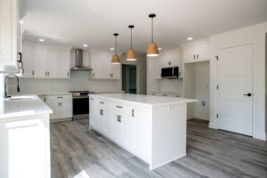 kitchen with white cabinets and island in new home