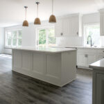kitchen with white cabinets and island in new home