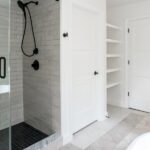 new bathroom with a shower and shelf storage space