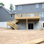 back view of a new home with a deck