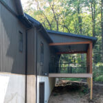 side view of the back of a new house with a covered porch
