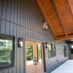 front door and windows on a covered porch in a new home