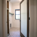 wooden and glass door leading to laundry room