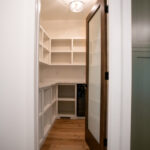 wooden and glass door leading to a pantry