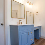 sink and vanity area in a new bathroom with blue cabinets