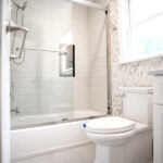 bathroom with toilet and shower tub after renovation