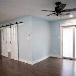 new living room with hardwood floors with sliding door to backyard