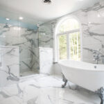 bathroom renovation with walk-in shower, claw foot tub, and marble details