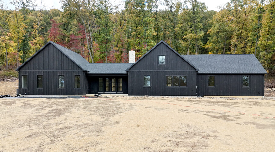 front view of a new home with black siding