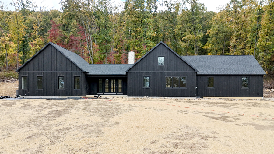 front view of a new home with black siding