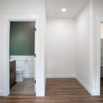 hallway with pantry and half bathroom