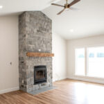 stone fireplace in living room of a new home