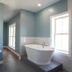 tub and sink in a new bathroom with blue and white walls