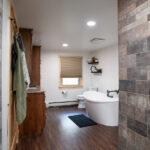 new bathroom in home addition with shower, tub, toilet, and sink