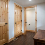 hallway for home addition with wooden doors