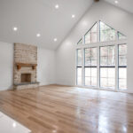 living room space with high ceilings, fireplace, and large windows