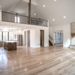 open living space in new home including living room, kitchen, half bathroom, and loft