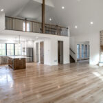 open living space in new home including living room, kitchen, half bathroom, and loft