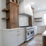 new kitchen with white counters and wood accents