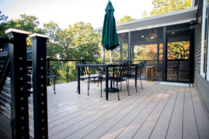 outdoor dining table with green umbrella on remodeled deck