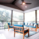 inside screen room with blue seating and knotty pine ceiling