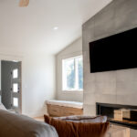 modern stone fireplace with a TV in a living room