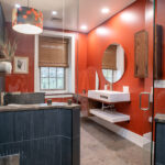 new modern bathroom with sink, circle mirror, and rain shower