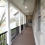 front porch with ceiling fans, hardwood, and railings