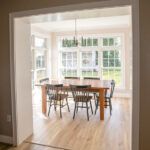 new dining room with hardwood floors, dining table, and large windows