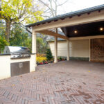 covered back patio with grill and pavers