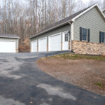 side view of a three car garage after a siding remodel