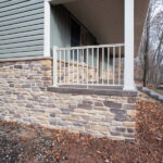 side view of a new front porch with stone details