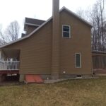 right side view of a home before a siding remodel