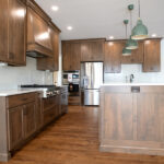 new kitchen with hardwood cabinets, island, and white countertop