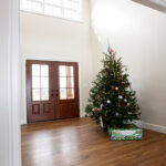 foyer in new home with large front door and christmas tree
