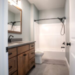 full bathroom with toilet, sink, and shower