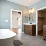 master bathroom with two sinks and bathtub