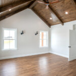large master bedroom with hardwood floor and ceiling