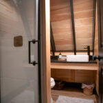 remodeled bathroom with walk in shower, sink, and toilet