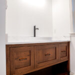 custom sink with hardwood cabinets and white marble countertop